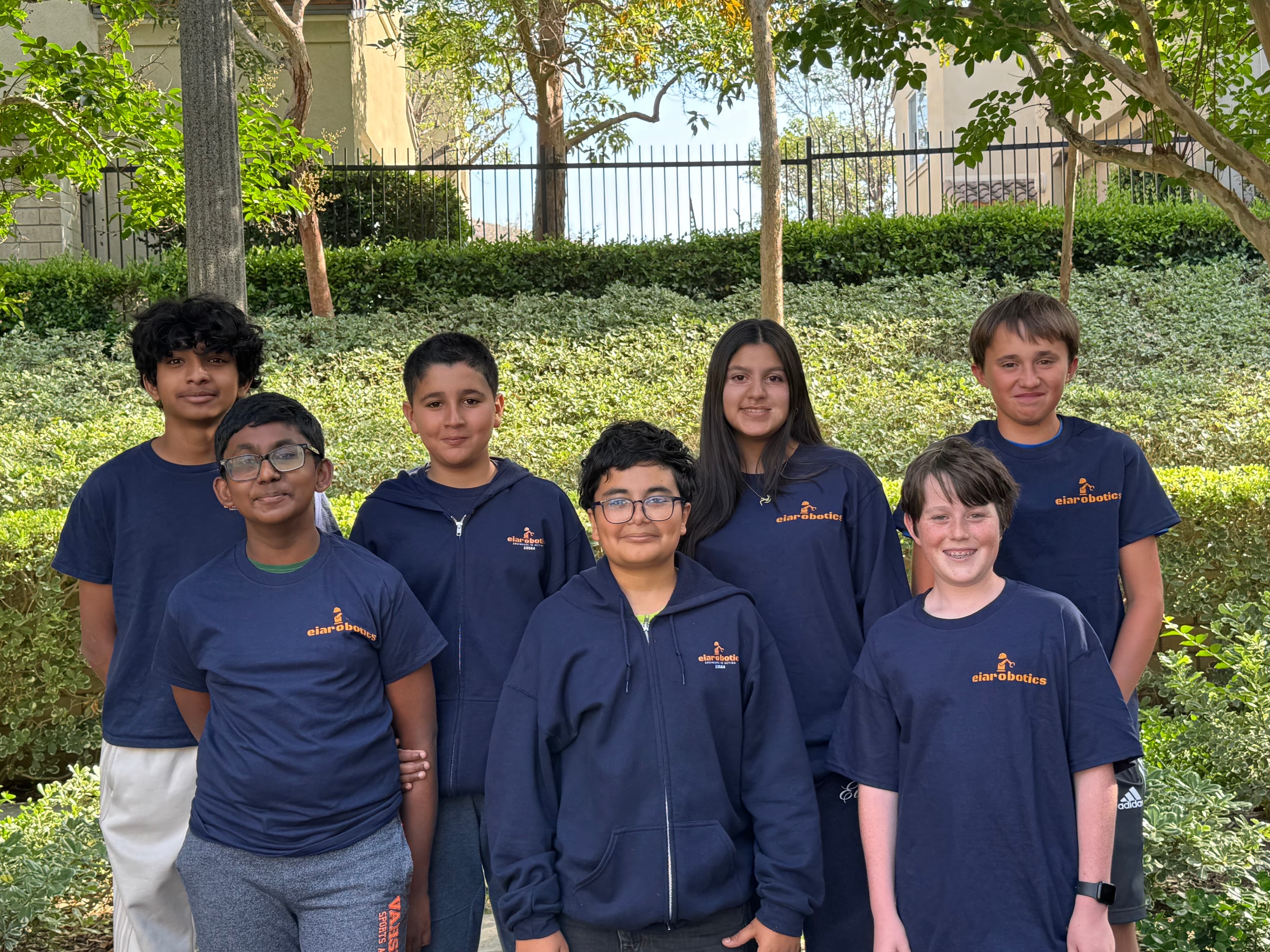 EIA Robotics students standing together outdoors in team shirts.
